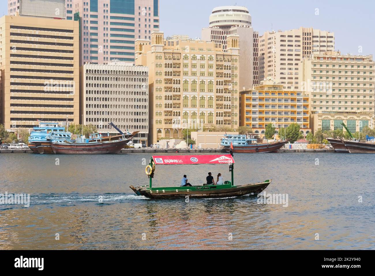 Water tourist ride on wooden Arabic boat Abra, water taxi RTA, popular mode of urban transport.Dubai, UAE. Stock Photo
