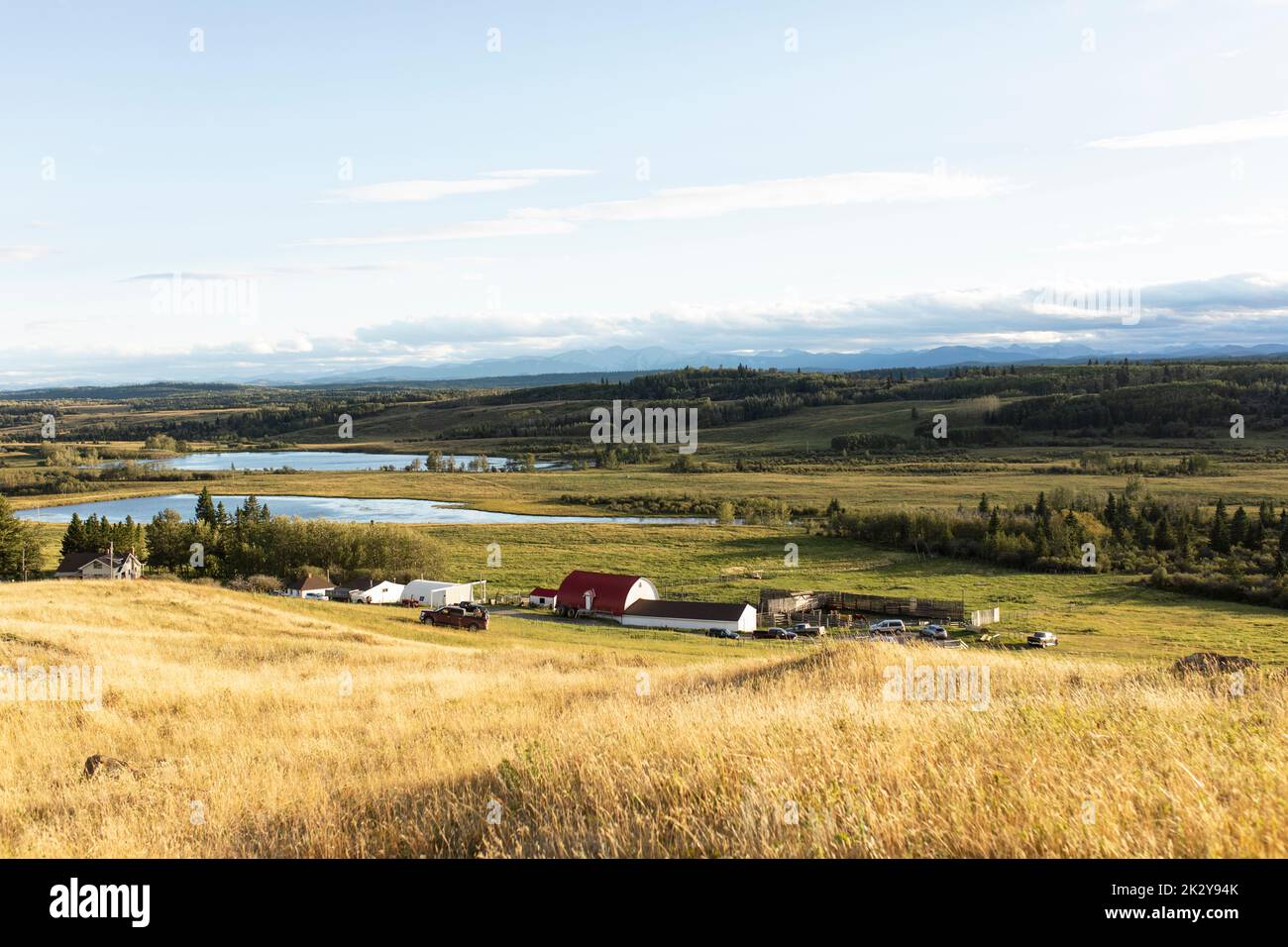Scenic landscape view sunny idyllic farm in vast countryside Stock Photo
