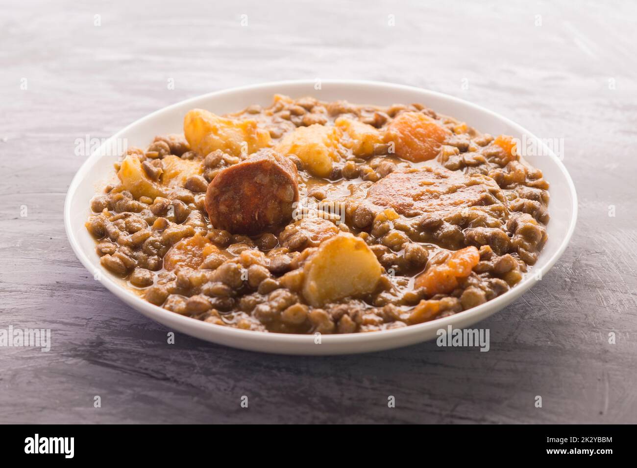 Spanish lentils with potatoes, carrot and chorizo Stock Photo Alamy