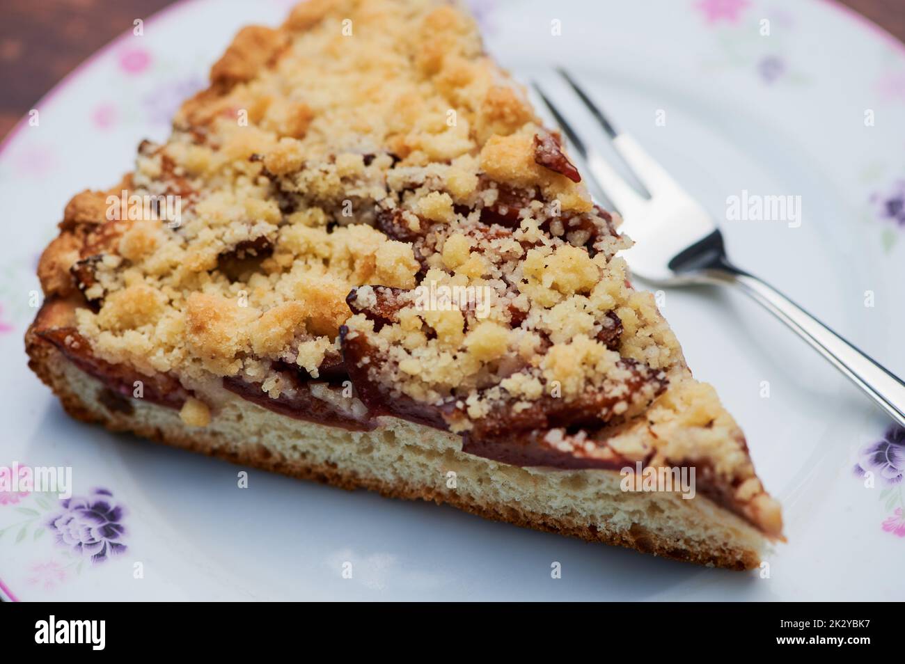 plum crumble cake on white plate Stock Photo