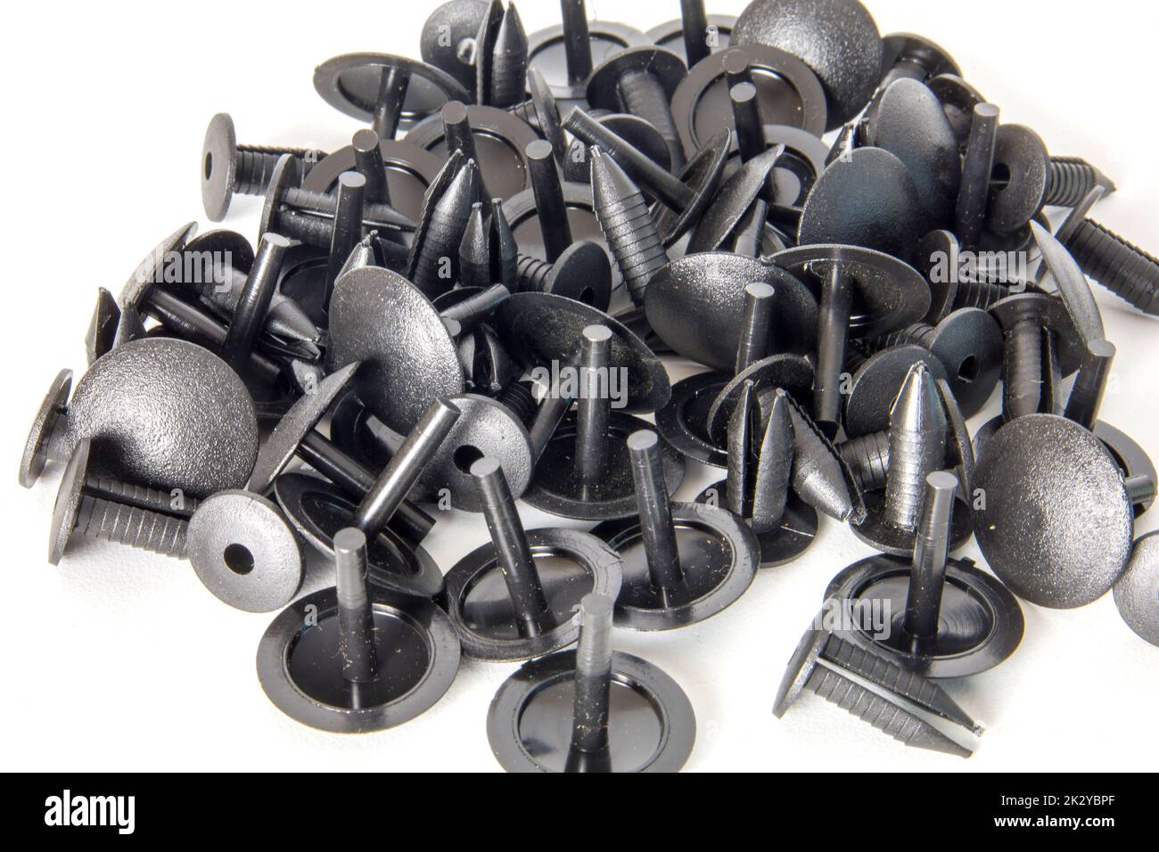 Black clips. Car spare parts isolated on white. Stock Photo