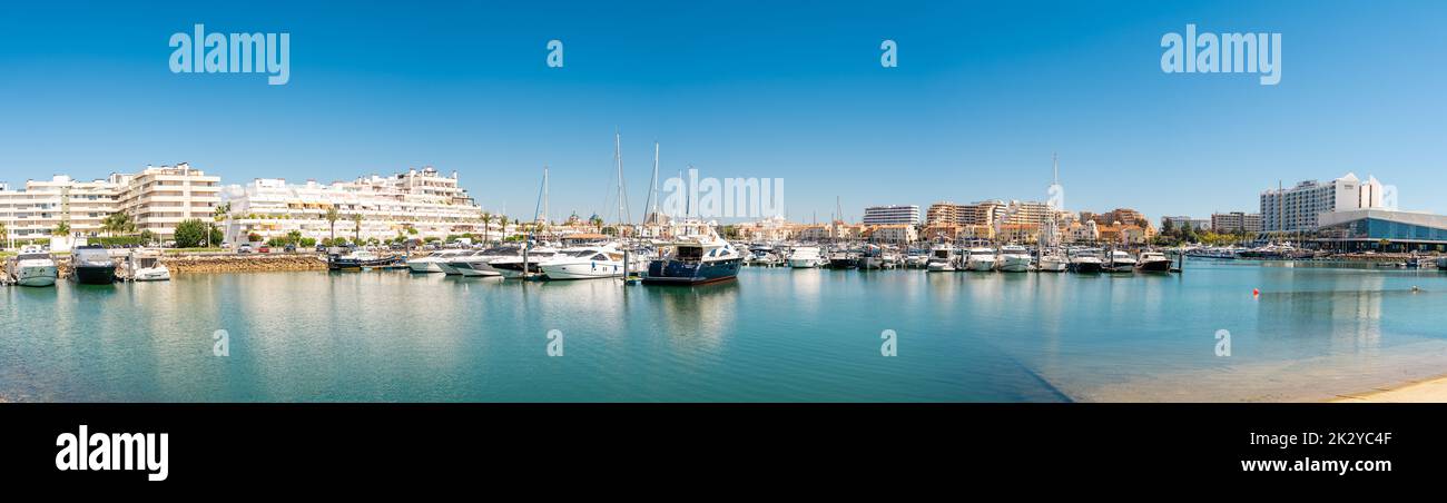 Panorama of luxury port of Vilamoura. Algarve region. Luxury travel destination in South of Portugal. Yacht docked, restaurants, luxury hotels Stock Photo