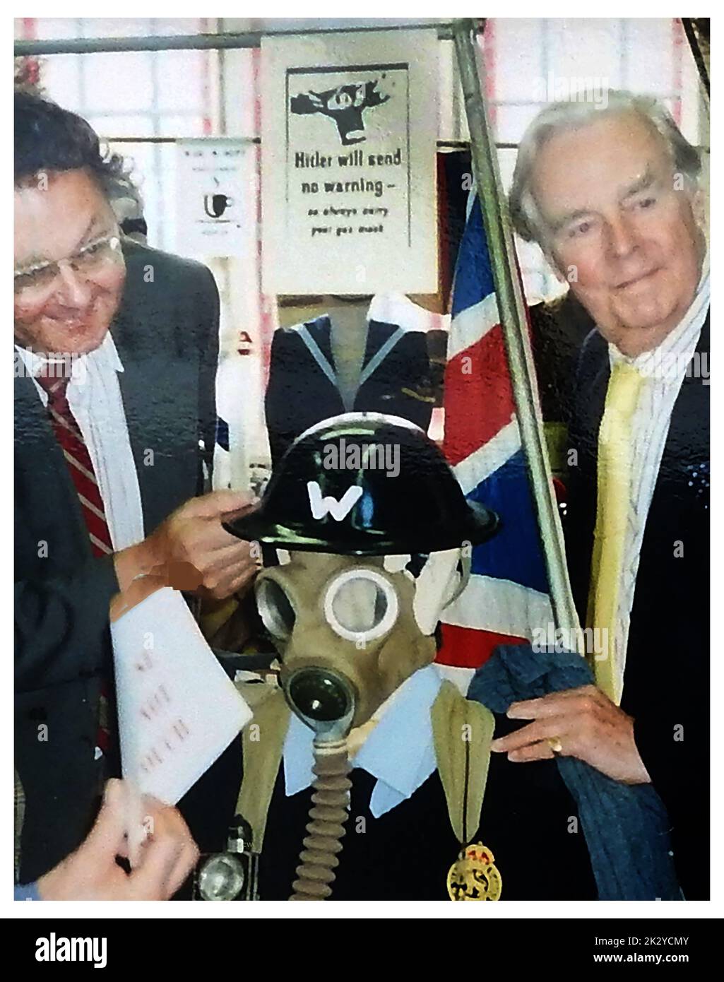 Veteran Actor, the late  Ian Carmichael, full name Ian Gillett Carmichael, OBE ( 1920 – 2010), examines a local  WWII defence corps wardens gas mask &  outfit  together with Whitby Archives founder & Director, Colin Waters (left) on the occasion of the official opening of the town's heritage centre in Grape Lane. Stock Photo
