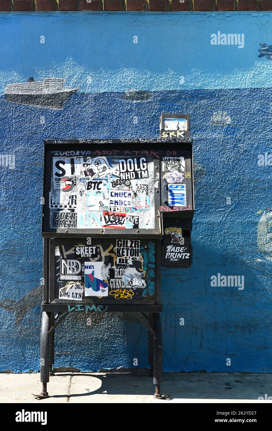 SAN PEDRO, CALIFORNIA - 09 SEPT 2022:  Newspaper machine covered with stickers and grafitti. Stock Photo