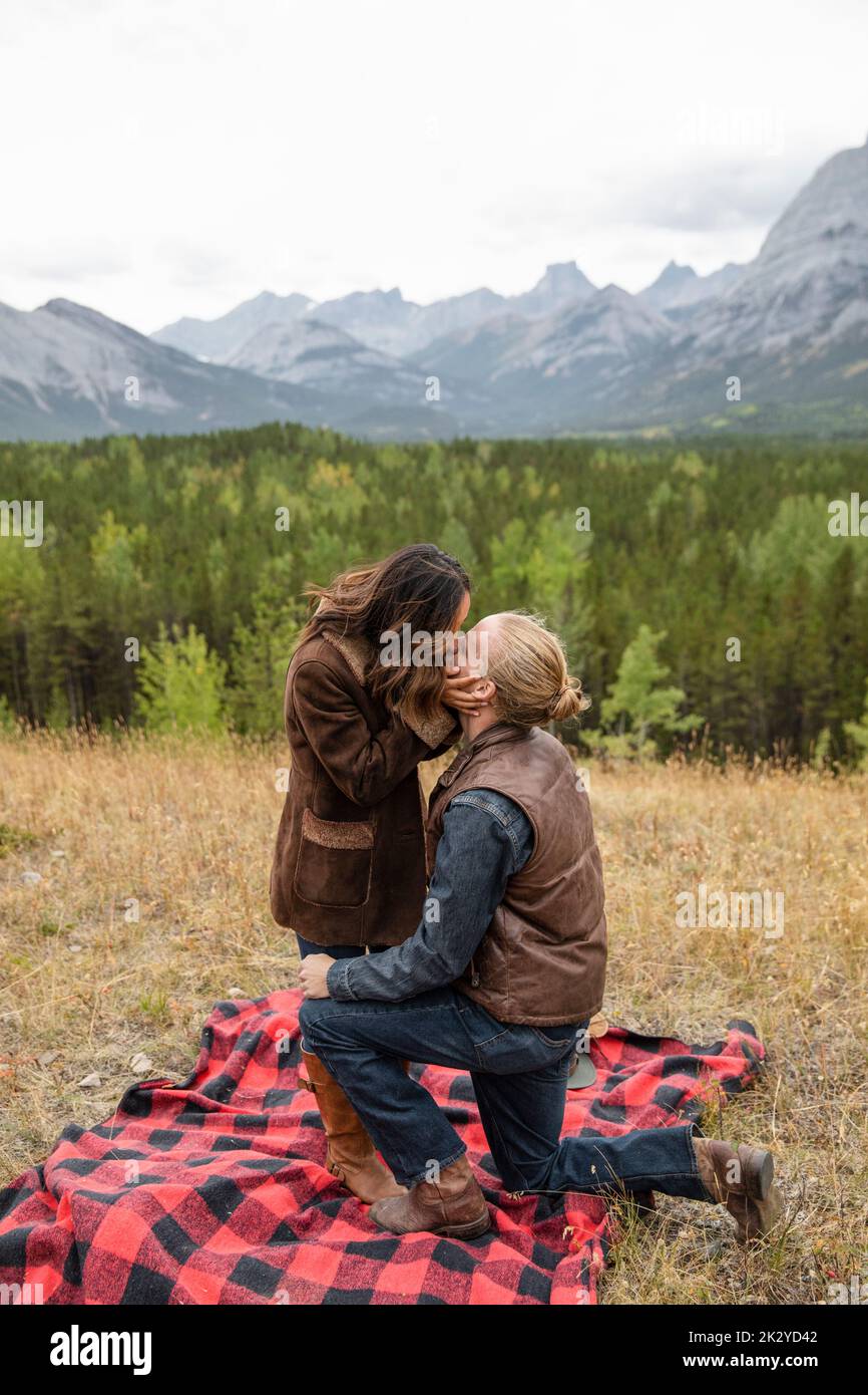 Romantic couple kissing on blanket in scenic mountains Stock Photo Alamy