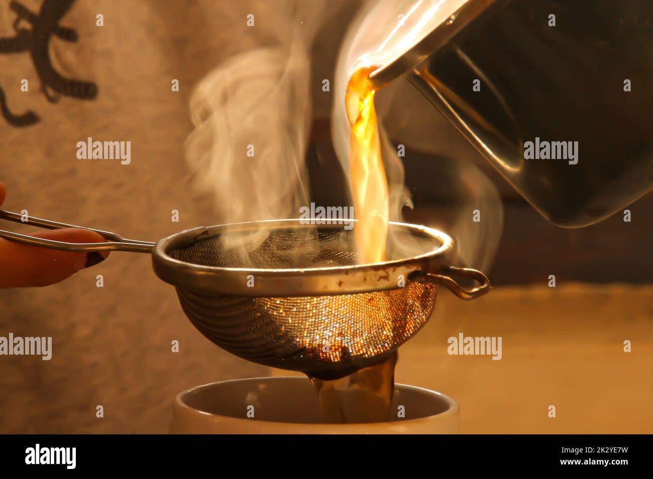 Straining Pot Tea pouring green tea from the pot into a cup with a strainer Stock Photo ...