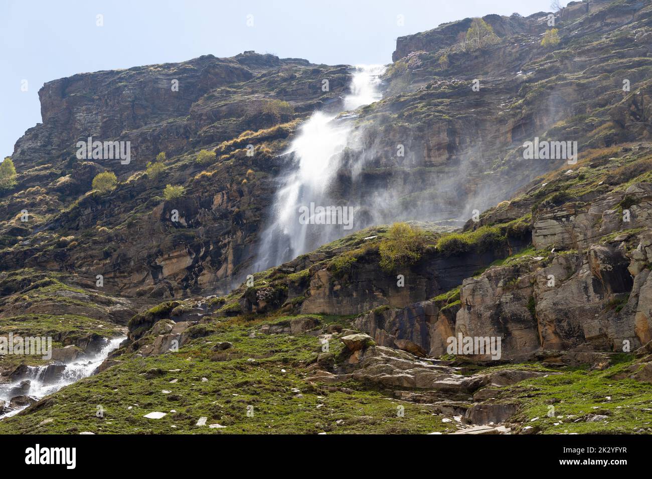 A scenic shot of a waterfall streaming through the high cliffs Stock ...