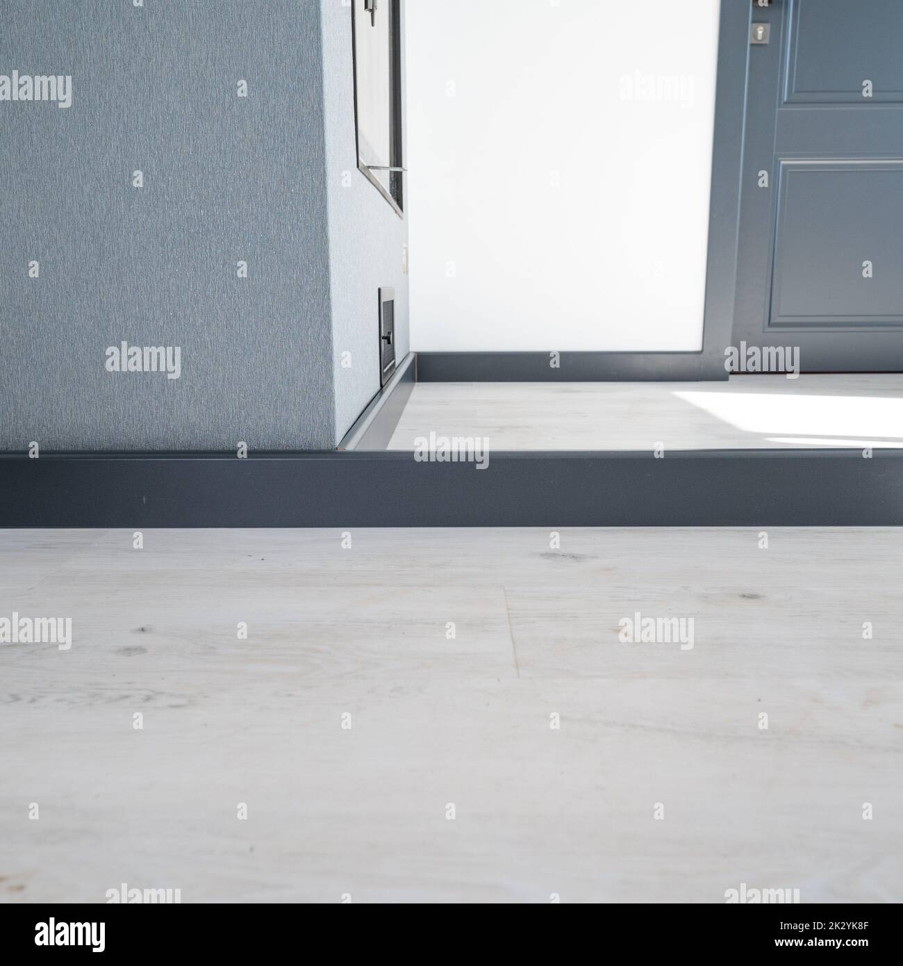 The plinth is dark gray to match the color of the door, mounting the plinth in the room, light