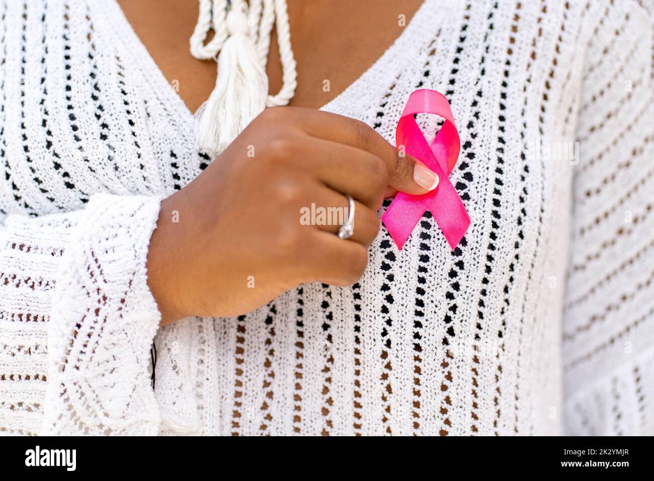 woman with pink ribbon for supporting people living and illness,  Breast Cancer Awareness concept Stock Photo