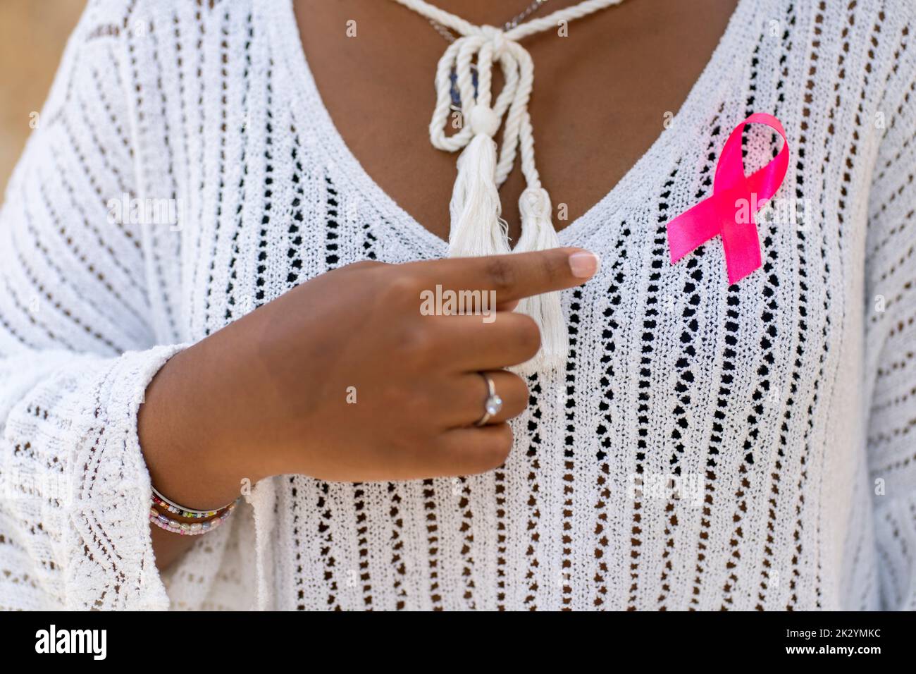 woman posing he holding light pink ribbon for supporting people living and illness,  Breast Cancer Awareness concept Stock Photo