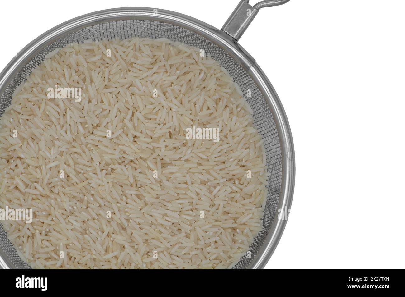 Raw white rice in a colander strainer isolated on white background Stock Photo