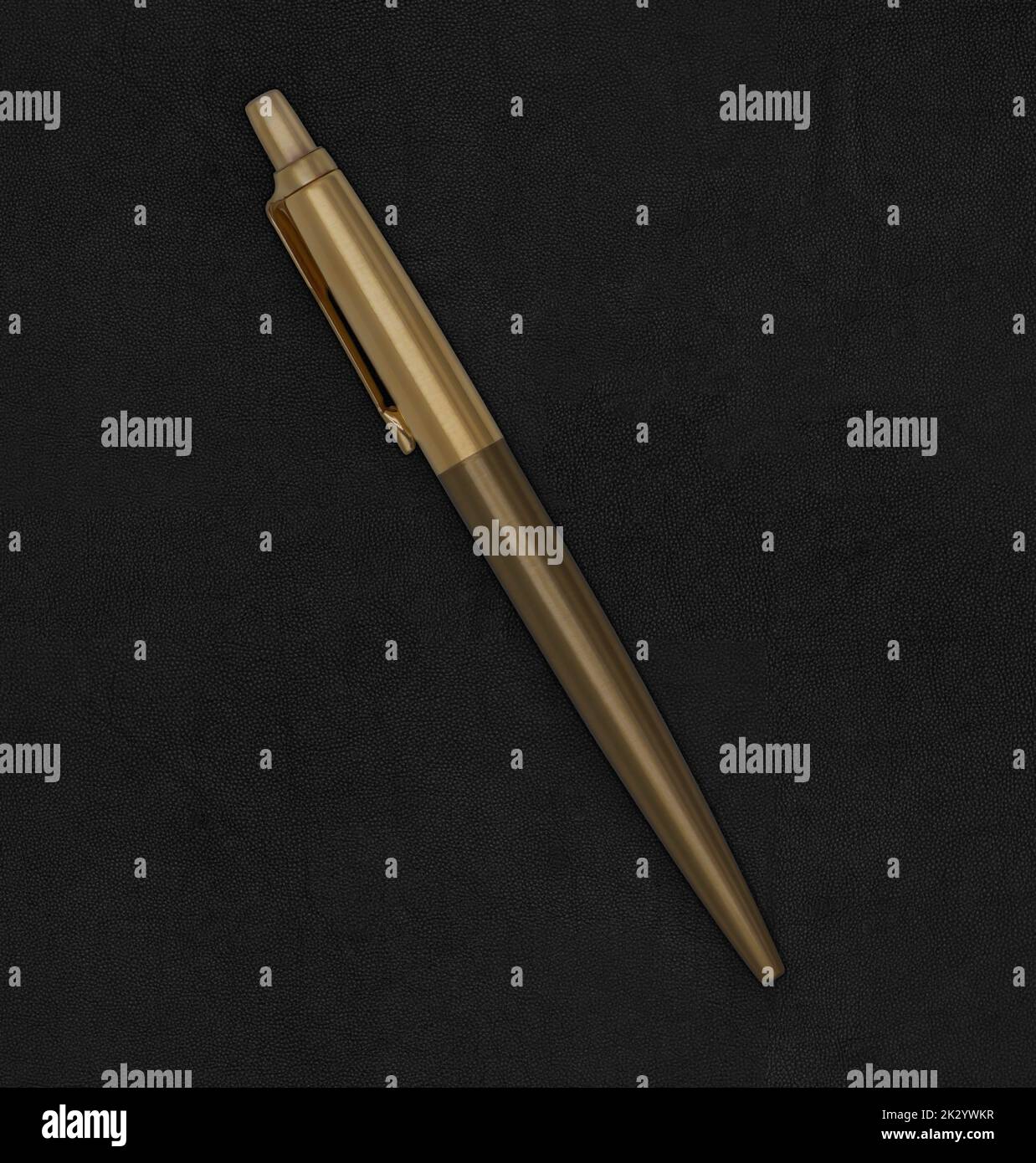 Premium quality golden Parker ballpoint pen on leather background Stock