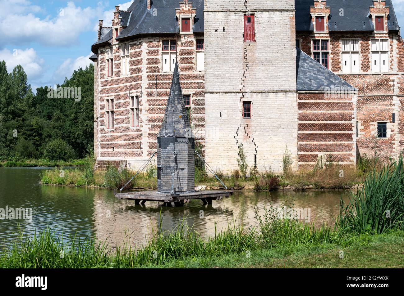 Holsbeek, Flemish Brabant Region, Belgium, 08 21 2022 - Landscape view over the pond and medieval castle Stock Photo