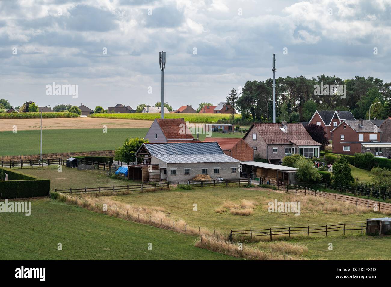 Tielt-Winge, Flemish Brabant, Belgium,  08 22 2022 - High angle view over farmhouses and agriculture fields Stock Photo