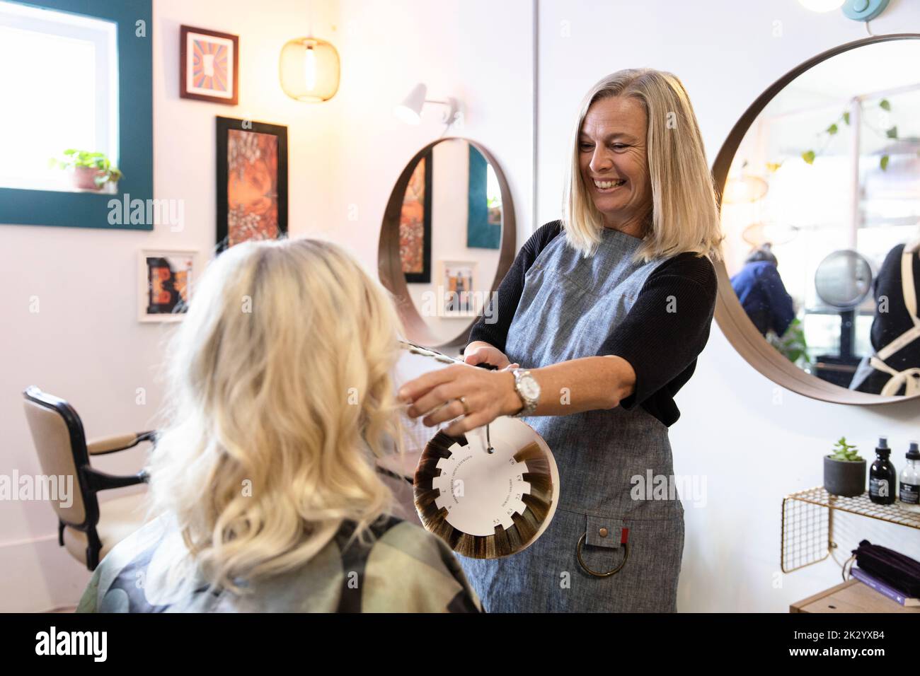 Hairdresser giving hair colour advice to customer Stock Photo Alamy