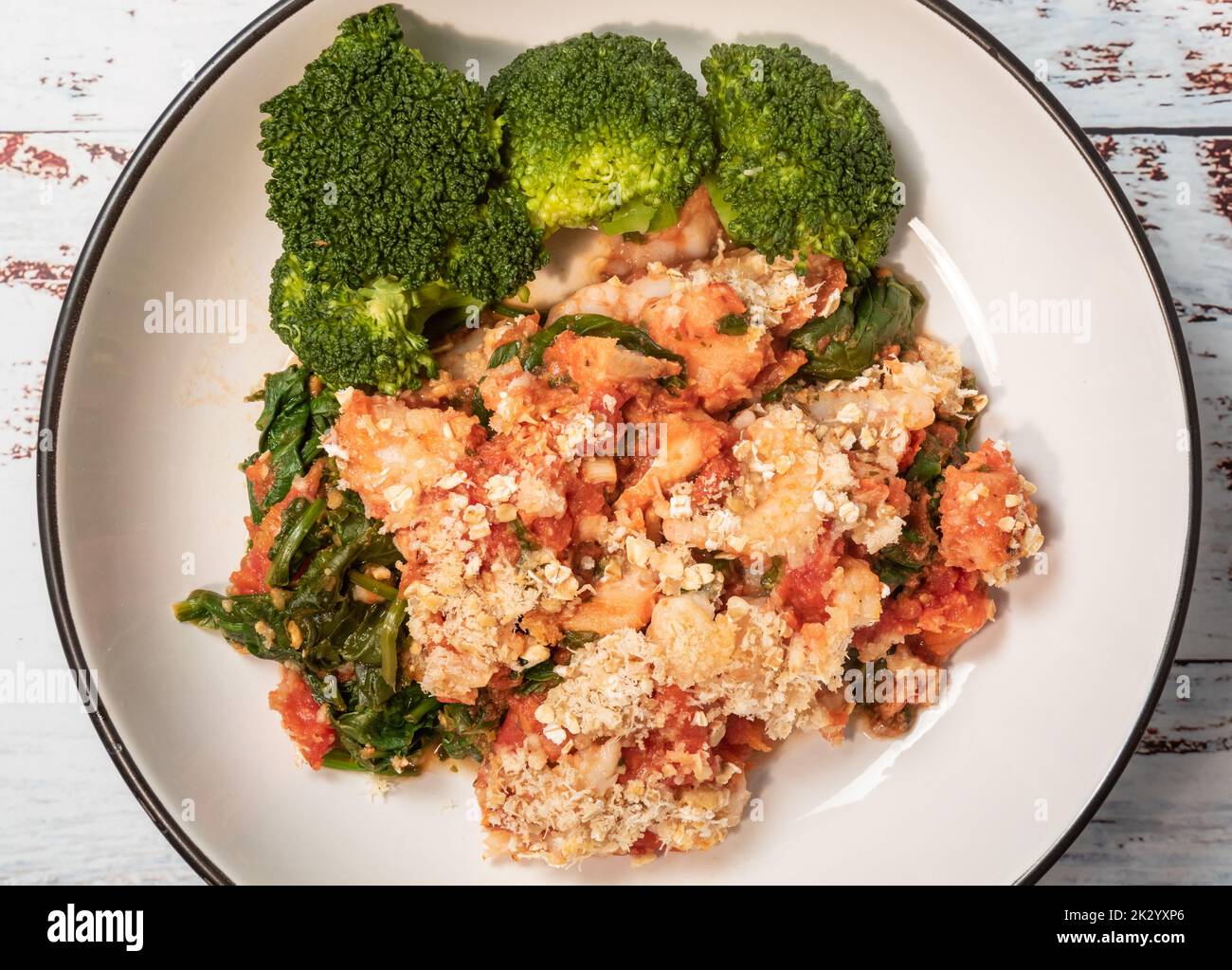 Oaty fish and prawn gratin from above Stock Photo