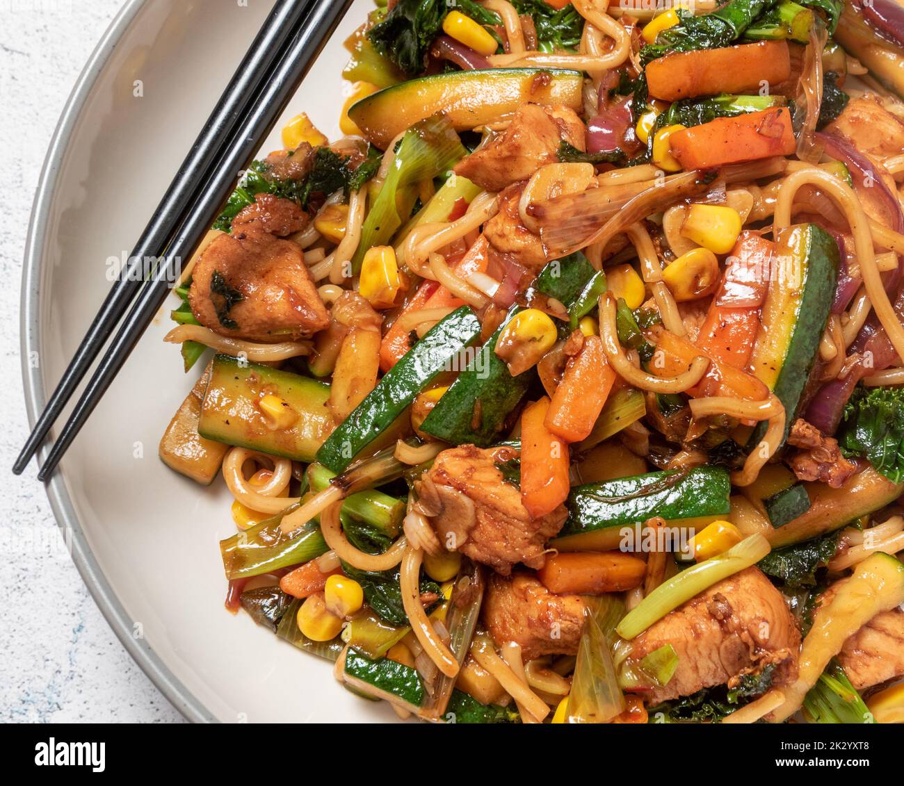 chicken stir fry with chopsticks, section Stock Photo
