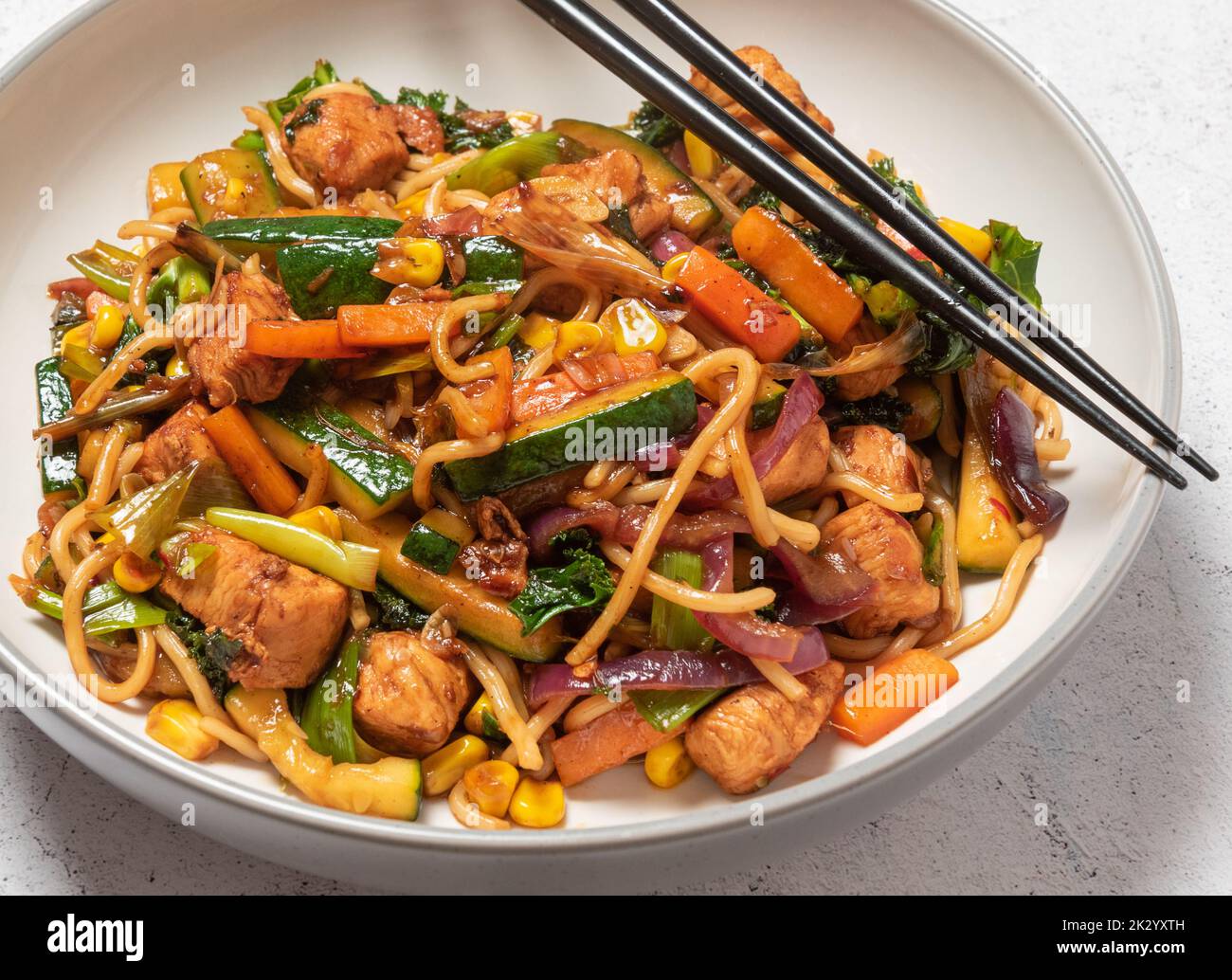 chicken stir fry with chopsticks Stock Photo