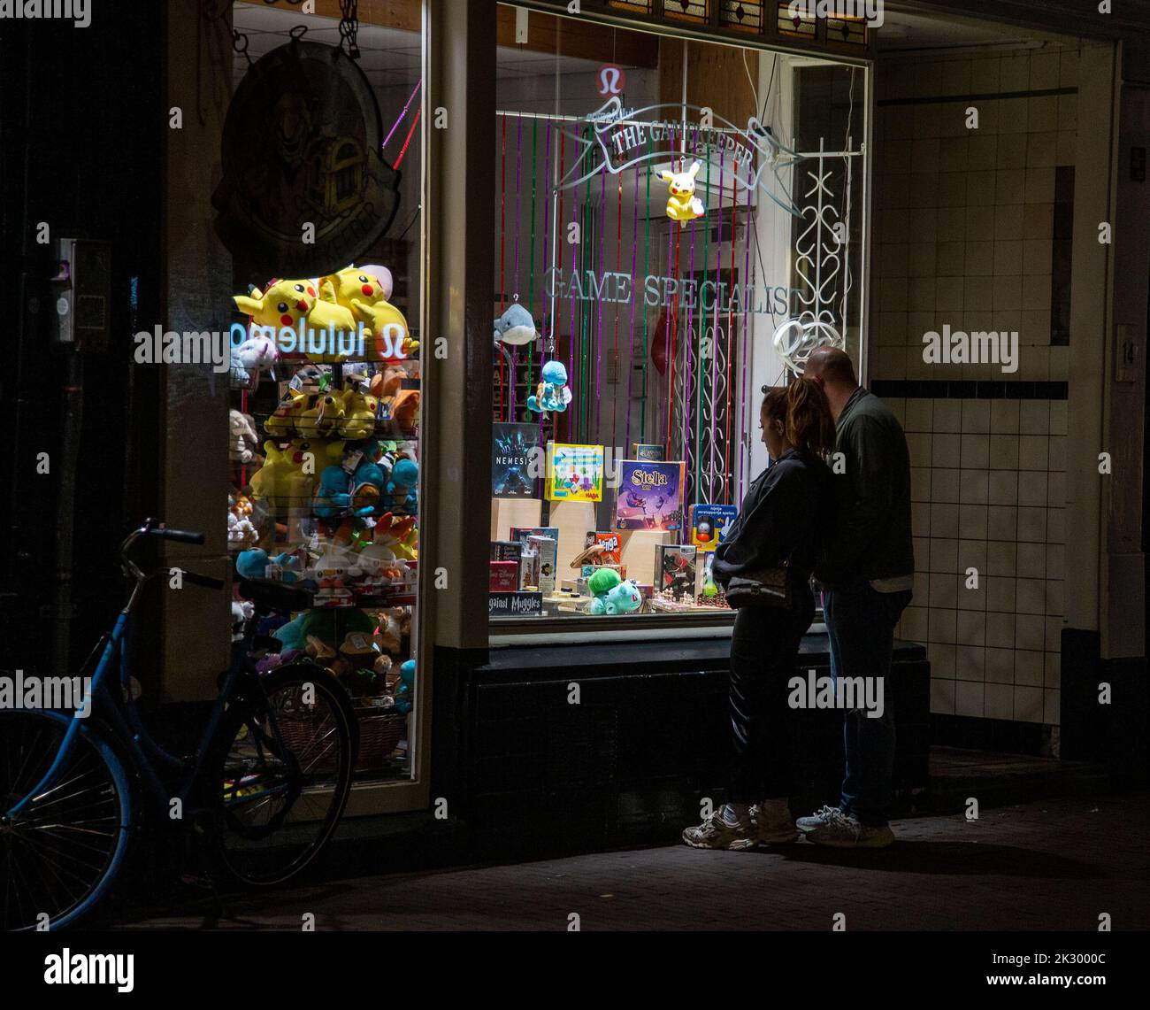 Couple looking at the window of an Amsterdam shop Stock Photo