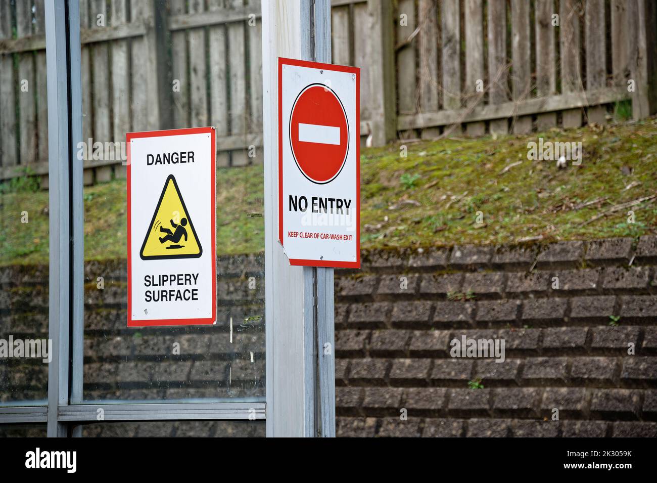 Slippery surface danger sign and no entry sign at car wash Stock Photo