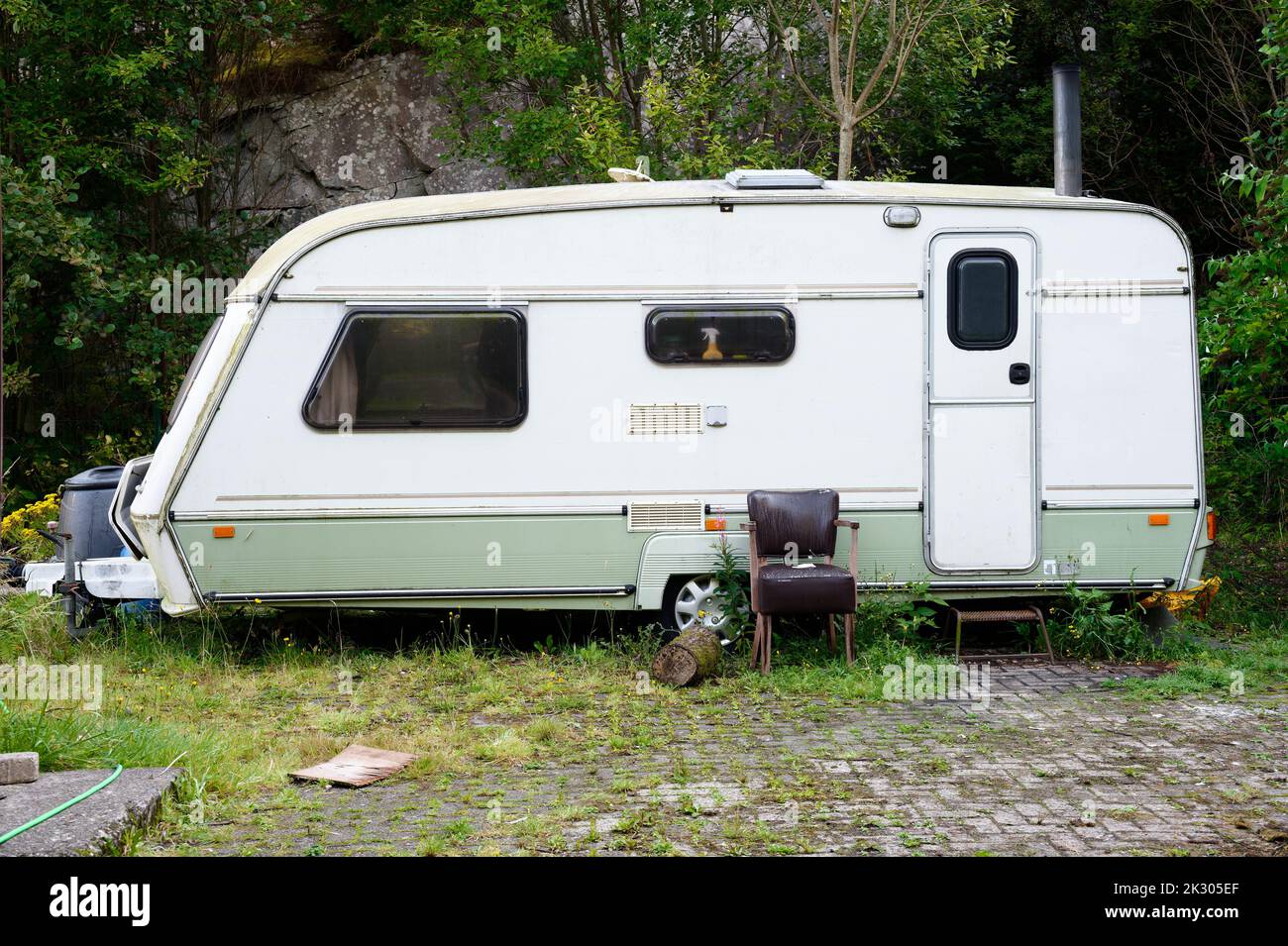 Caravan abandoned and dumped in park waiting to be removed Stock Photo