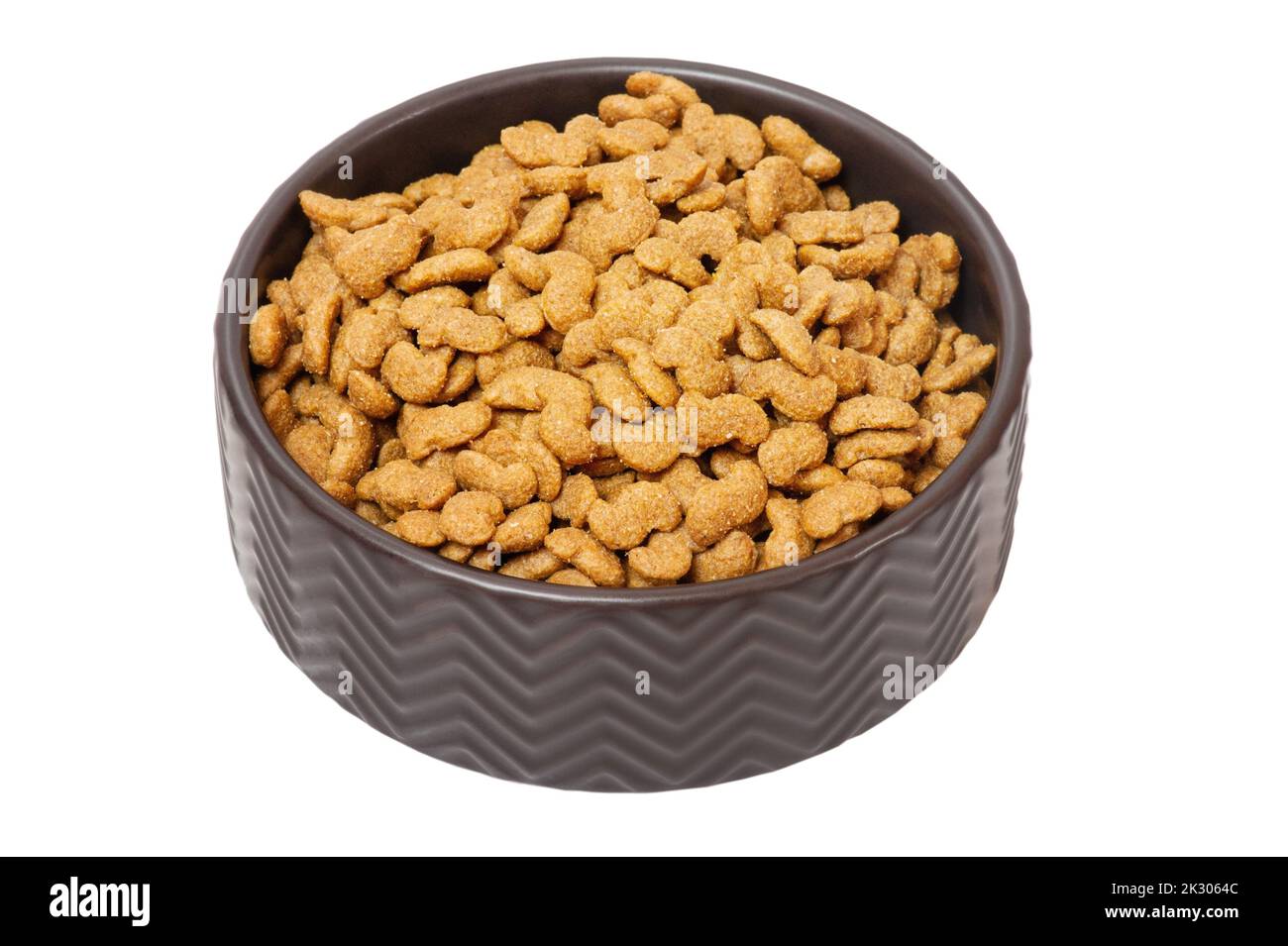 Food for animals. Dry food for dogs or cats in a black bowl isolated on