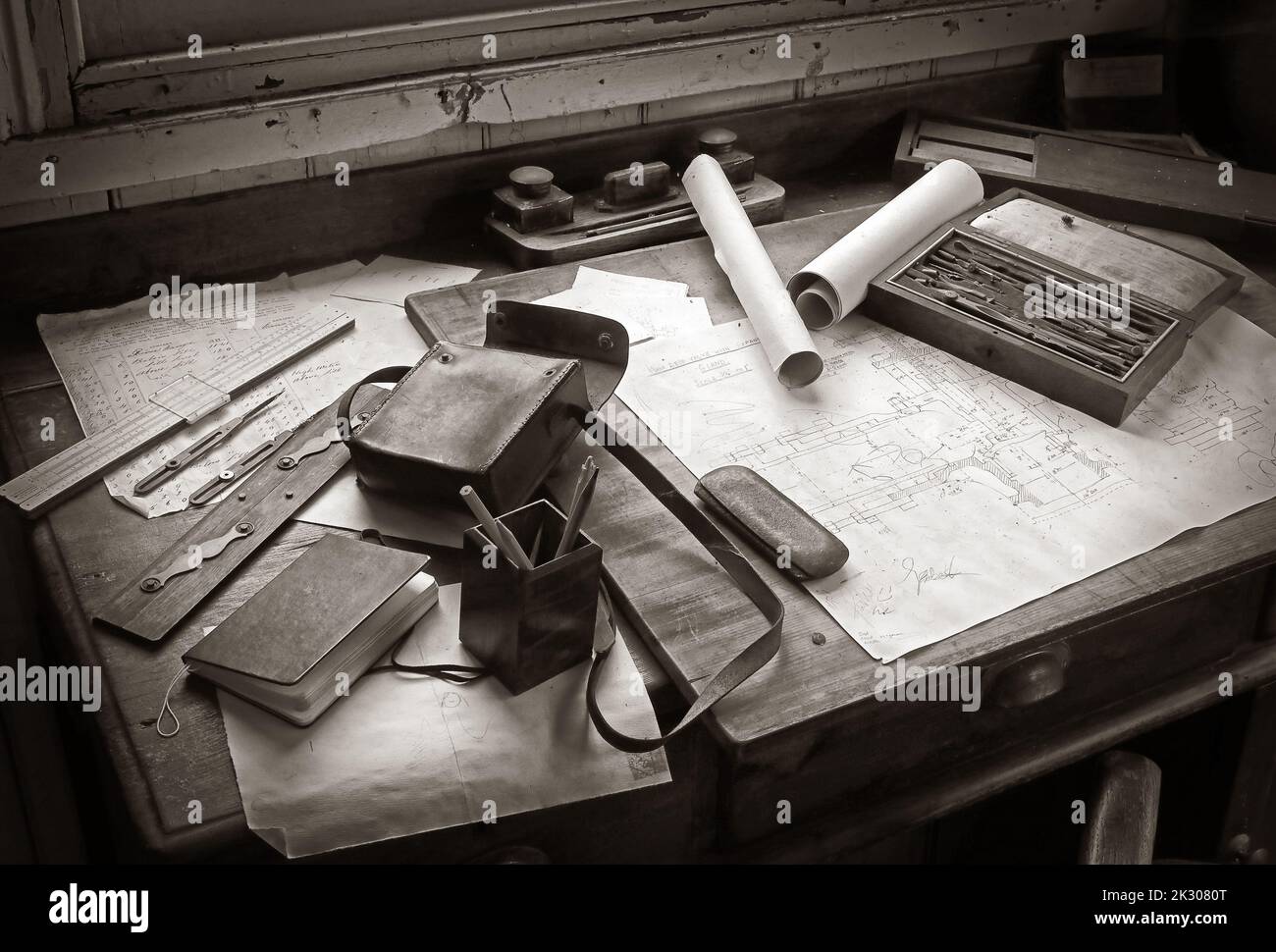 Monochrome old fashioned draughtsman's desk, blueprint, engineering drawing, pencils, instruments, rule, office desk ink & tools Stock Photo