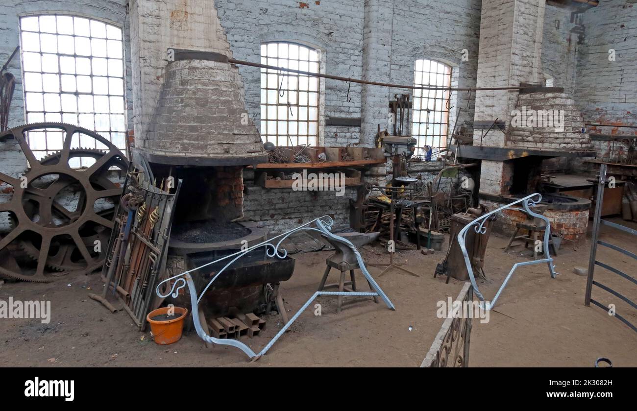 Interior of blacksmiths shop, forge, ironwork, casting, shaping, canalside works, Cheshire, England, UK Stock Photo