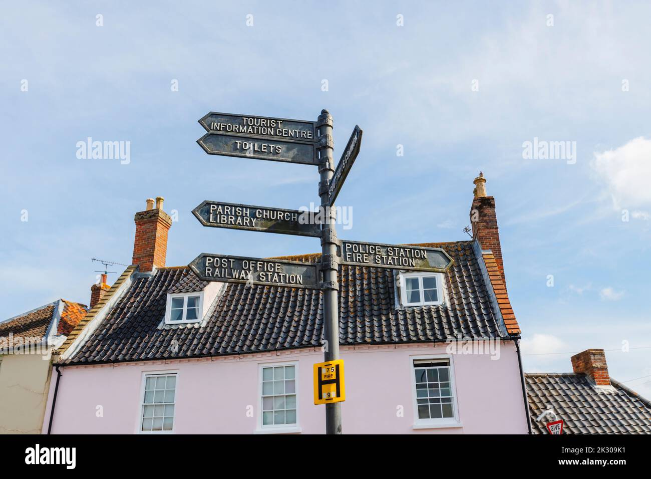 Signpost pointing to local amenities and places of interest in the centre of Holt, a small historic Georgian market town in north Norfolk, England Stock Photo