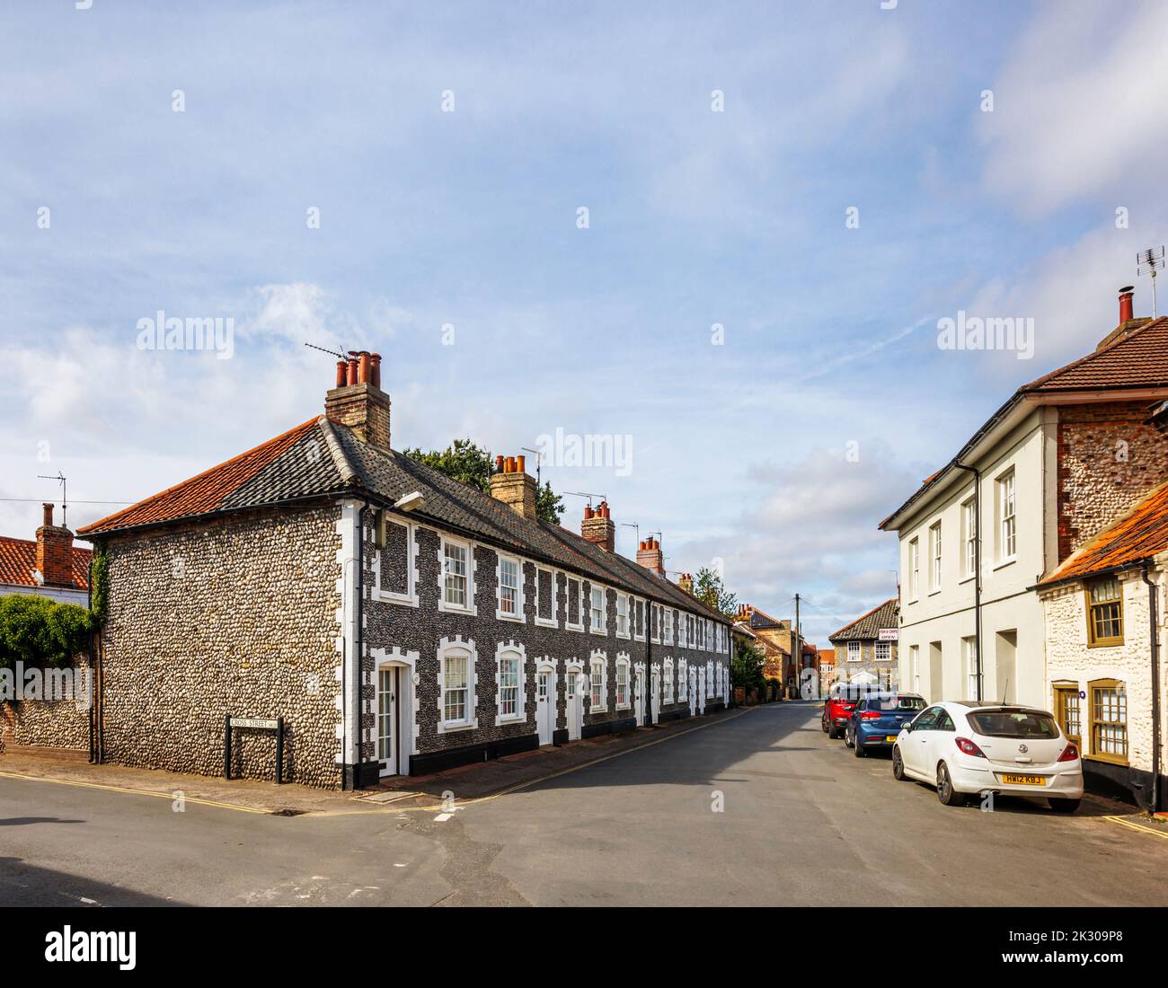 Terrace of local architectural style houses with flint stone walls in Holt, a small historic Georgian market town in north Norfolk, England Stock Photo