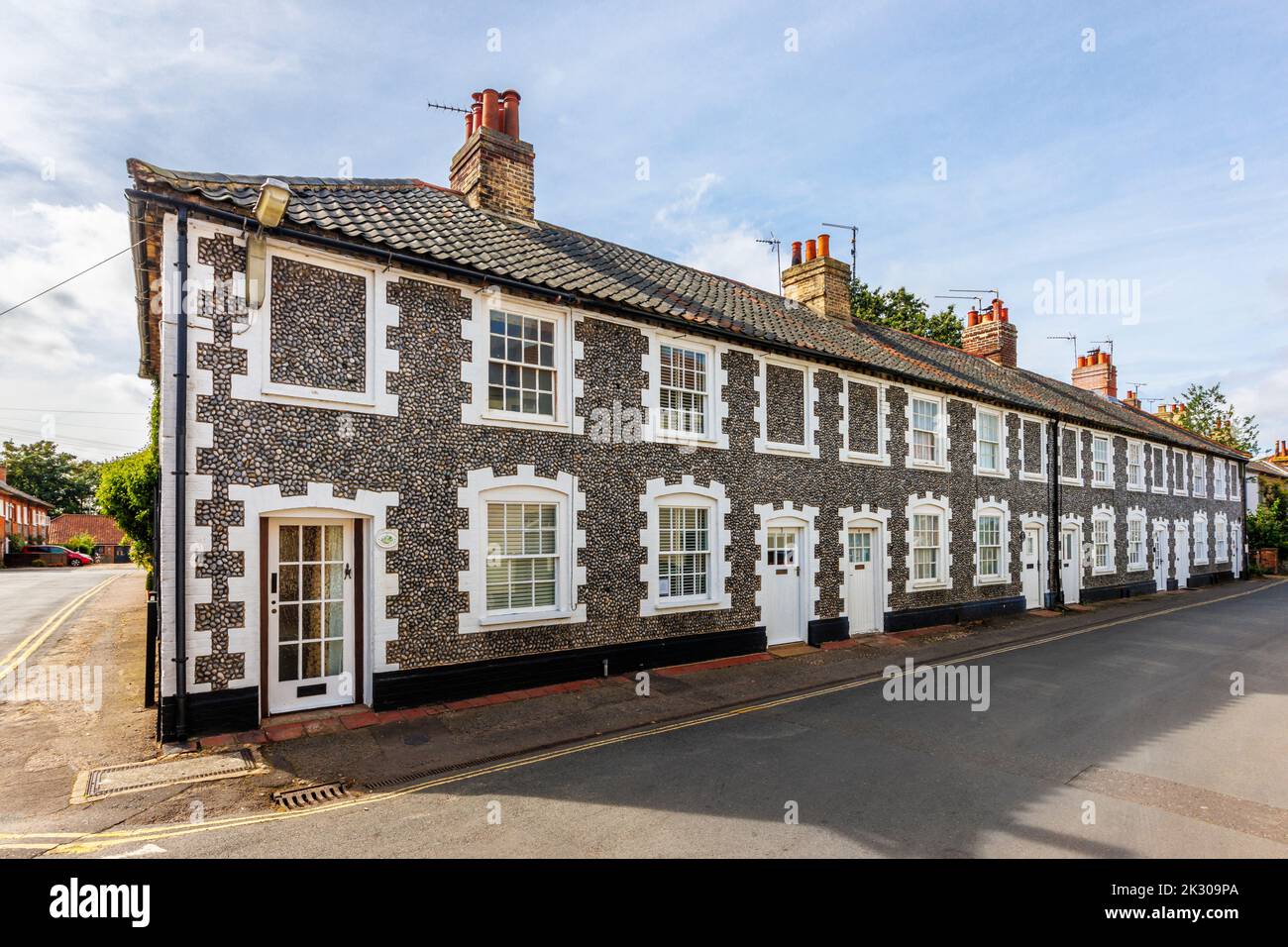 Terrace of local architectural style houses with flint stone walls in