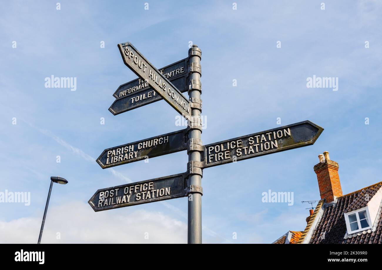 Signpost pointing to local amenities and places of interest in the centre of Holt, a small historic Georgian market town in north Norfolk, England Stock Photo