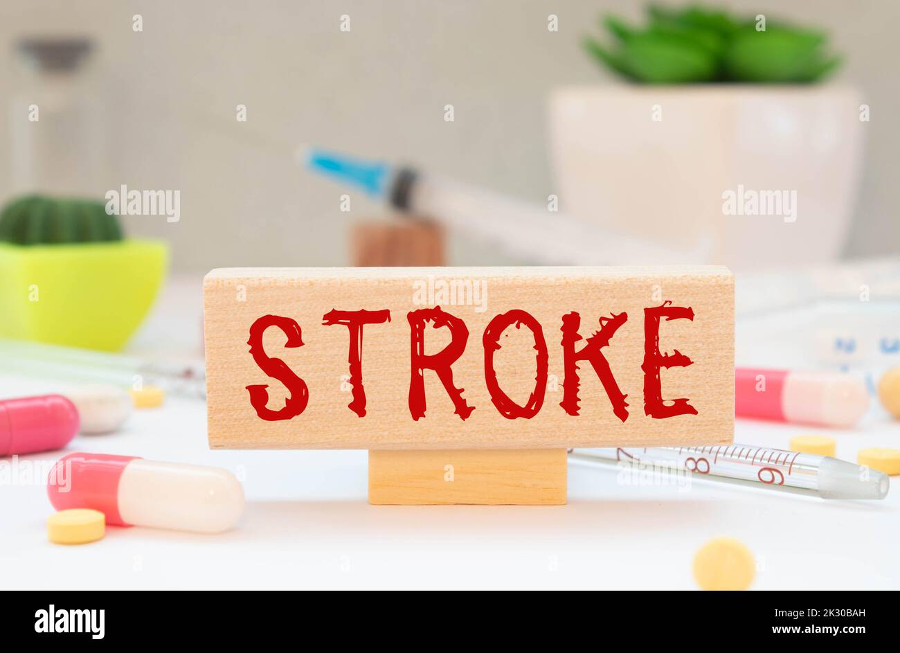 Stroke prostate text card on the doctor's desk next to a thermometer, stethoscope and tablets. Stock Photo