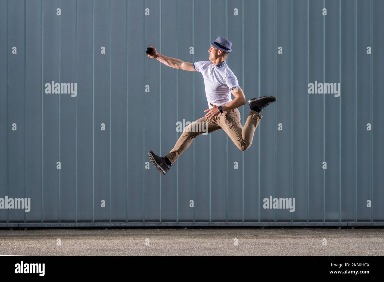 Man mobile phone jumping joy hi-res stock photography and images - Alamy