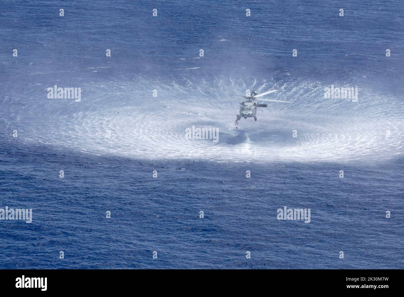220922-N-XN177-1815 PHILIPPINE SEA (Sept. 22, 2022) – A naval air crewman jumps from an MH-60S Sea Hawk helicopter assigned to Helicopter Sea Combat Squadron (HSC) 23 during a search and rescue (SAR) swimmer training evolution Sept. 22, 2022. HSC-23 is embarked aboard amphibious assault carrier USS Tripoli (LHA 7). Tripoli is operating in the U.S. 7th Fleet area of operations to enhance interoperability with allies and partners and serve as a ready response force to defend peace and maintain stability in the Indo-Pacific region.  (U.S. Navy photo by Mass Communication Specialist 1st Class Pete Stock Photo