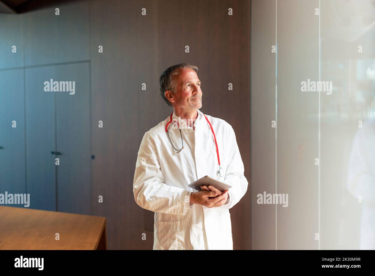 Doctor standing near pensive hi-res stock photography and images - Alamy