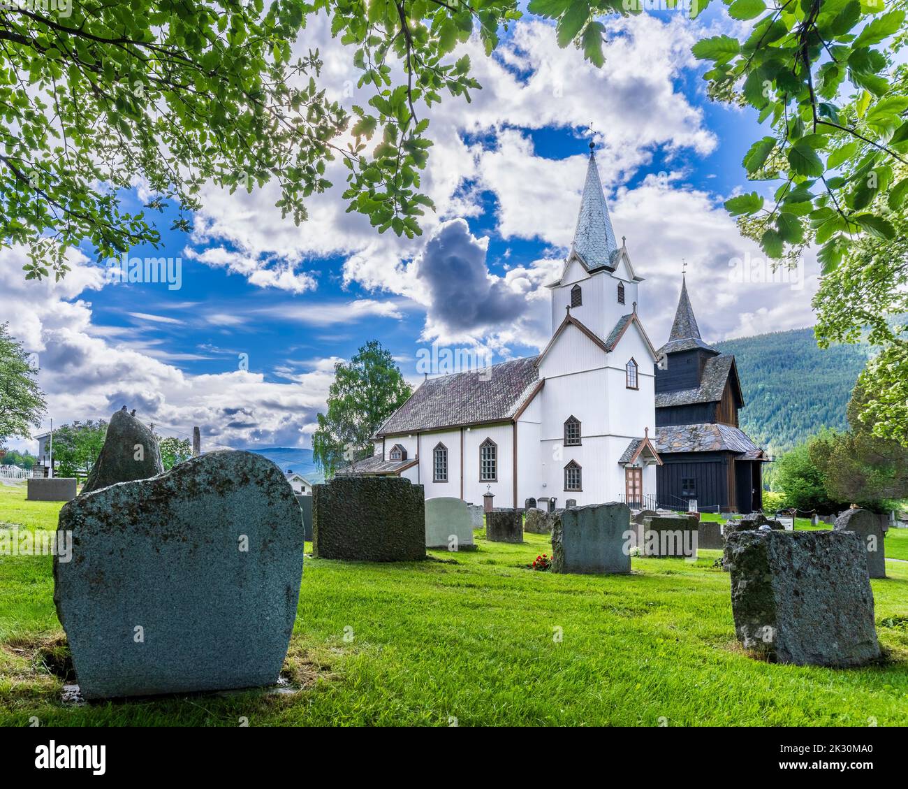 Norway, Viken, Torpo, Cemetery tombstones with rural church in background Stock Photo