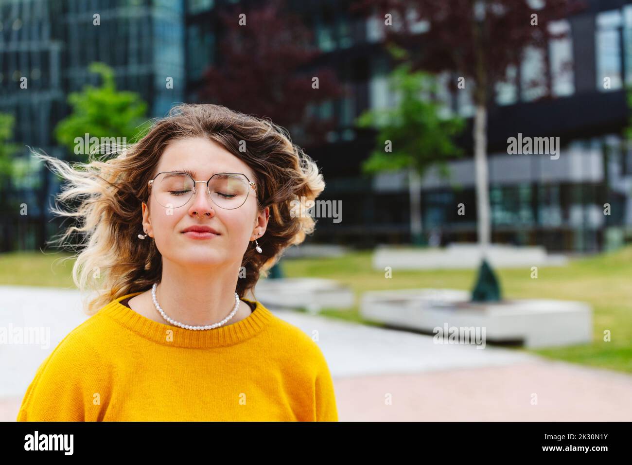 Young blond woman with eyes closed and tousled hair Stock Photo - Alamy