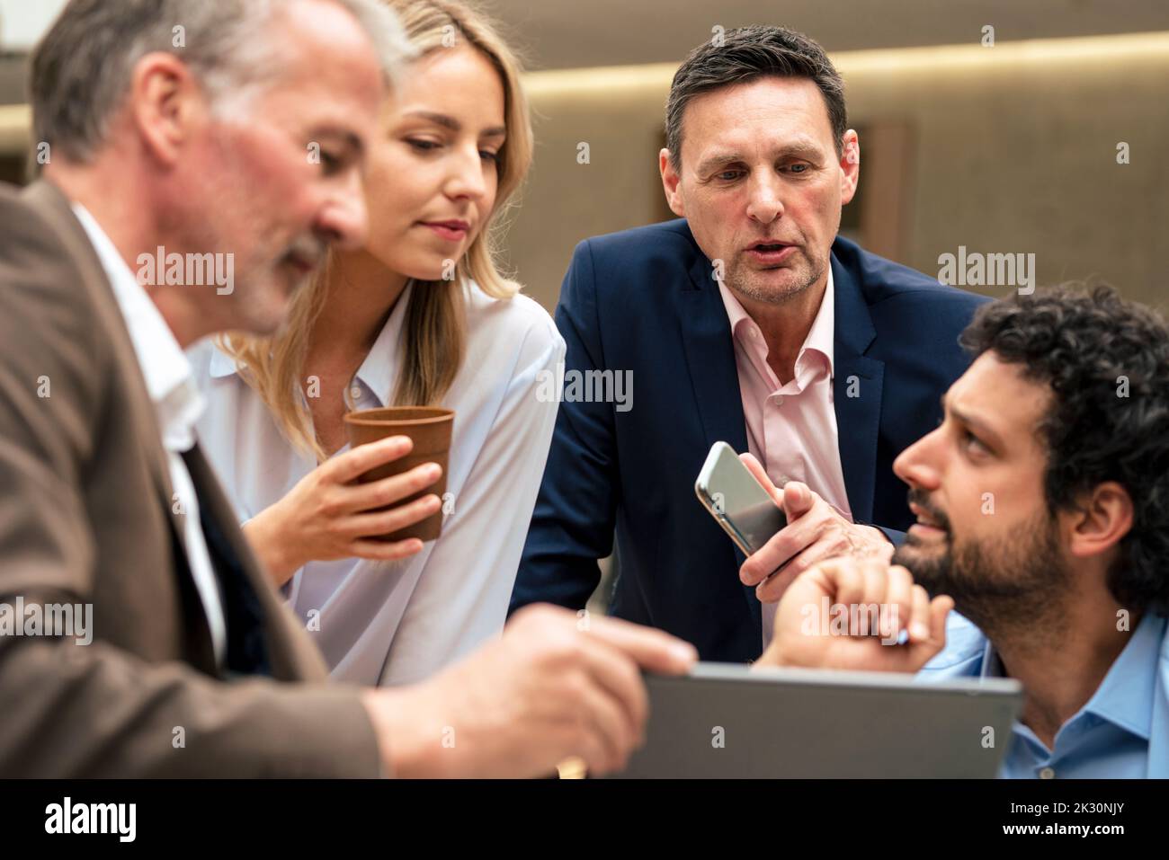 Business colleagues discussing strategy over tablet computer Stock Photo
