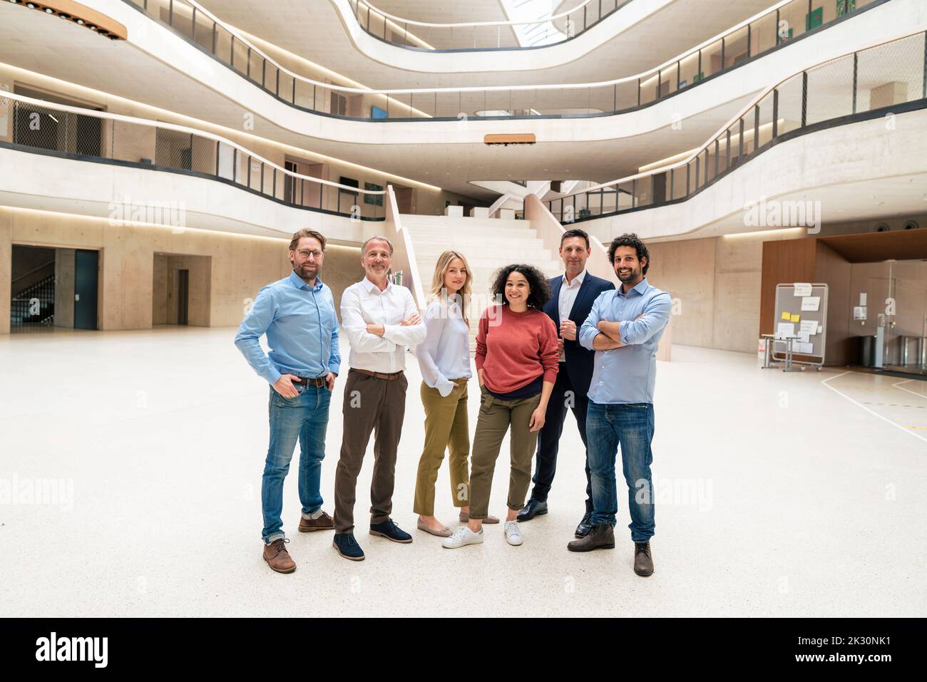 Smiling multiracial business colleagues standing in lobby Stock Photo ...