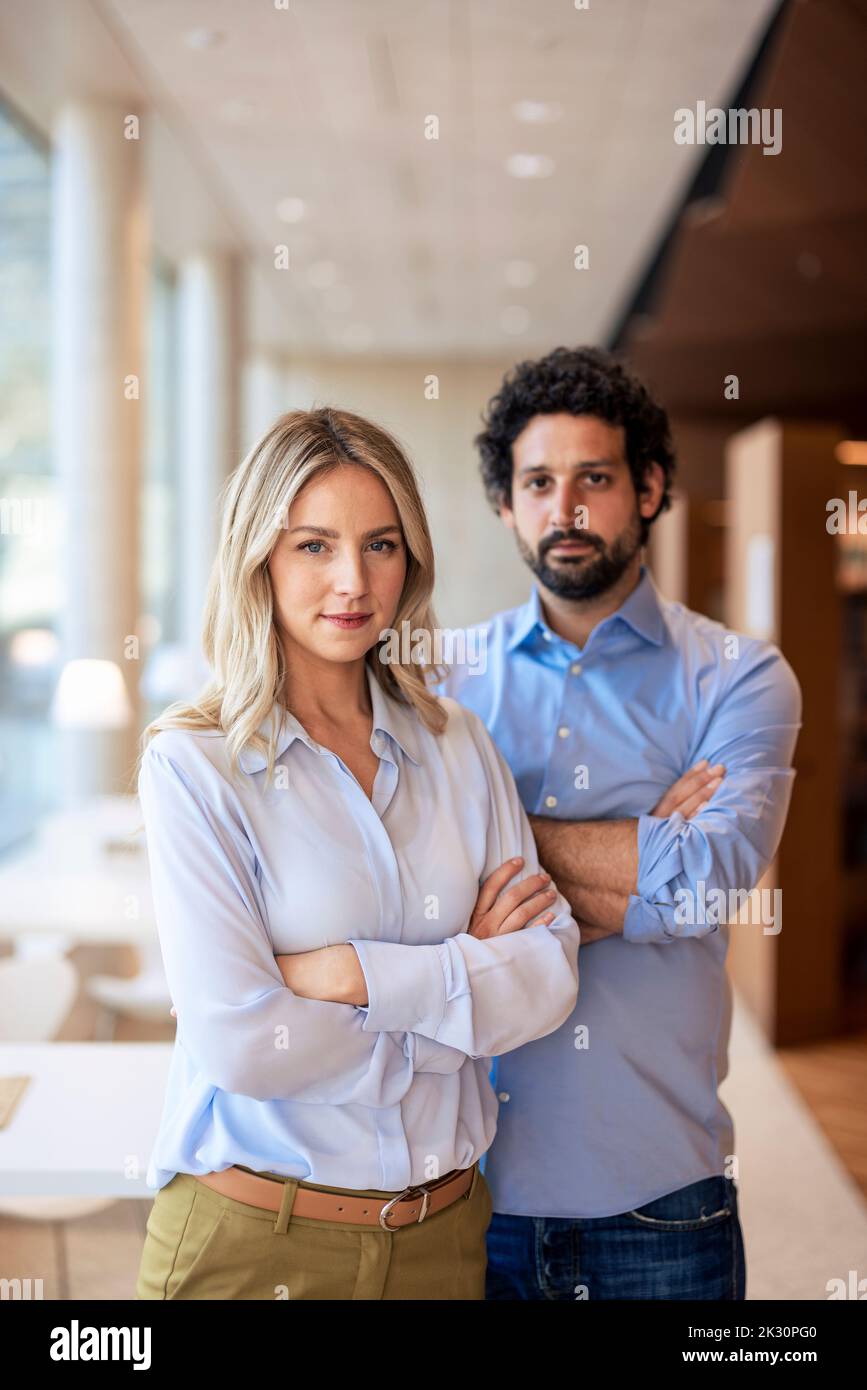 Confident professors with arms crossed in library Stock Photo