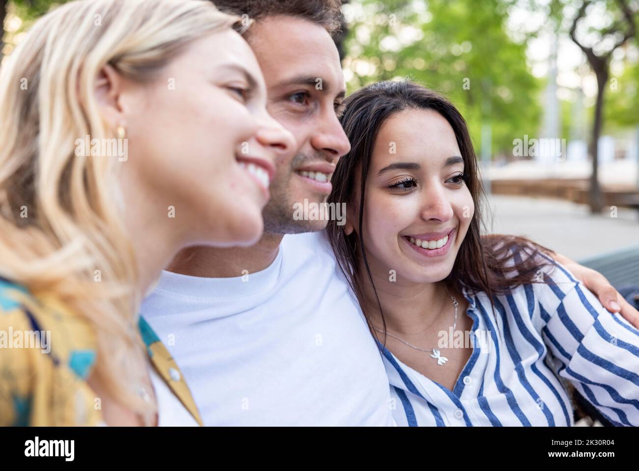 Happy young women with man at park Stock Photo
