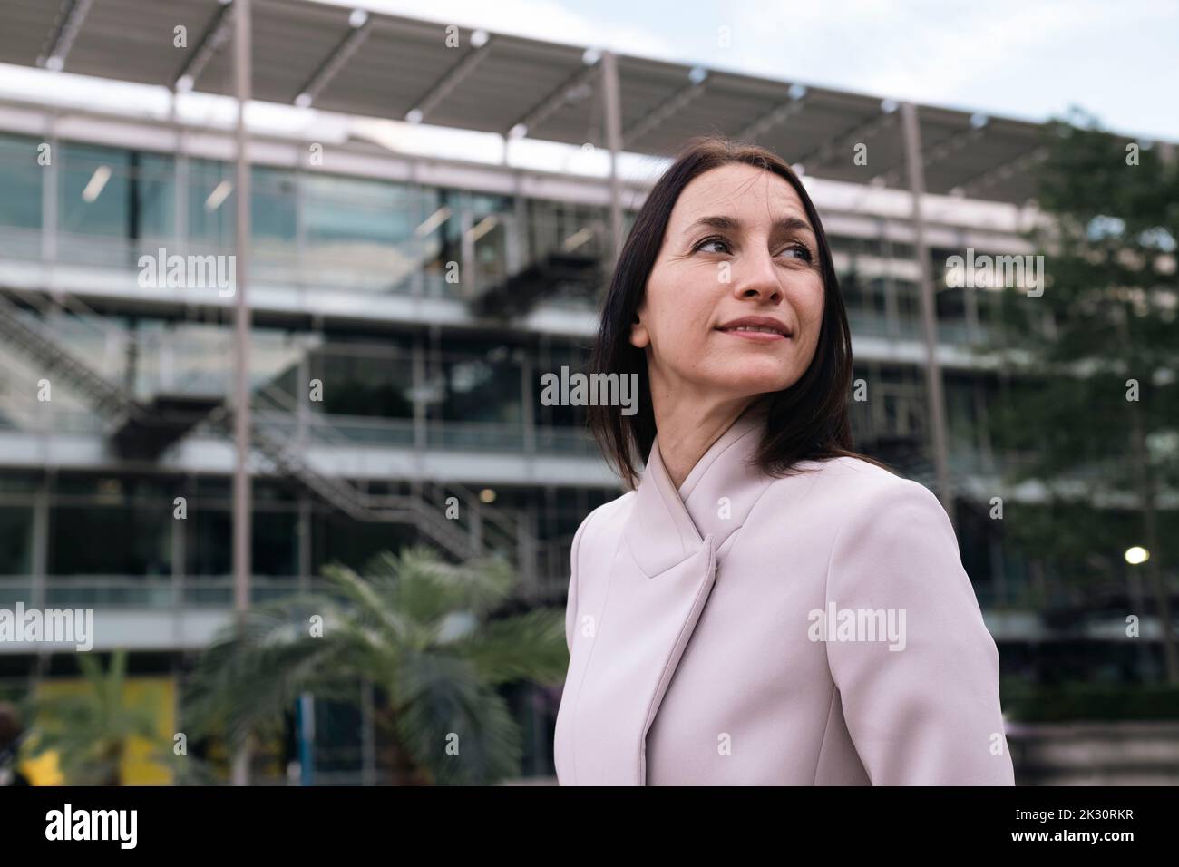Mature businesswoman outside office building exterior Stock Photo