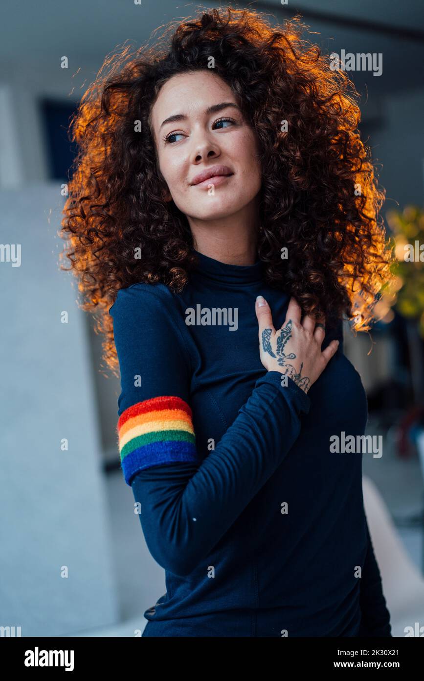 Smiling young woman with curly hair Stock Photo - Alamy