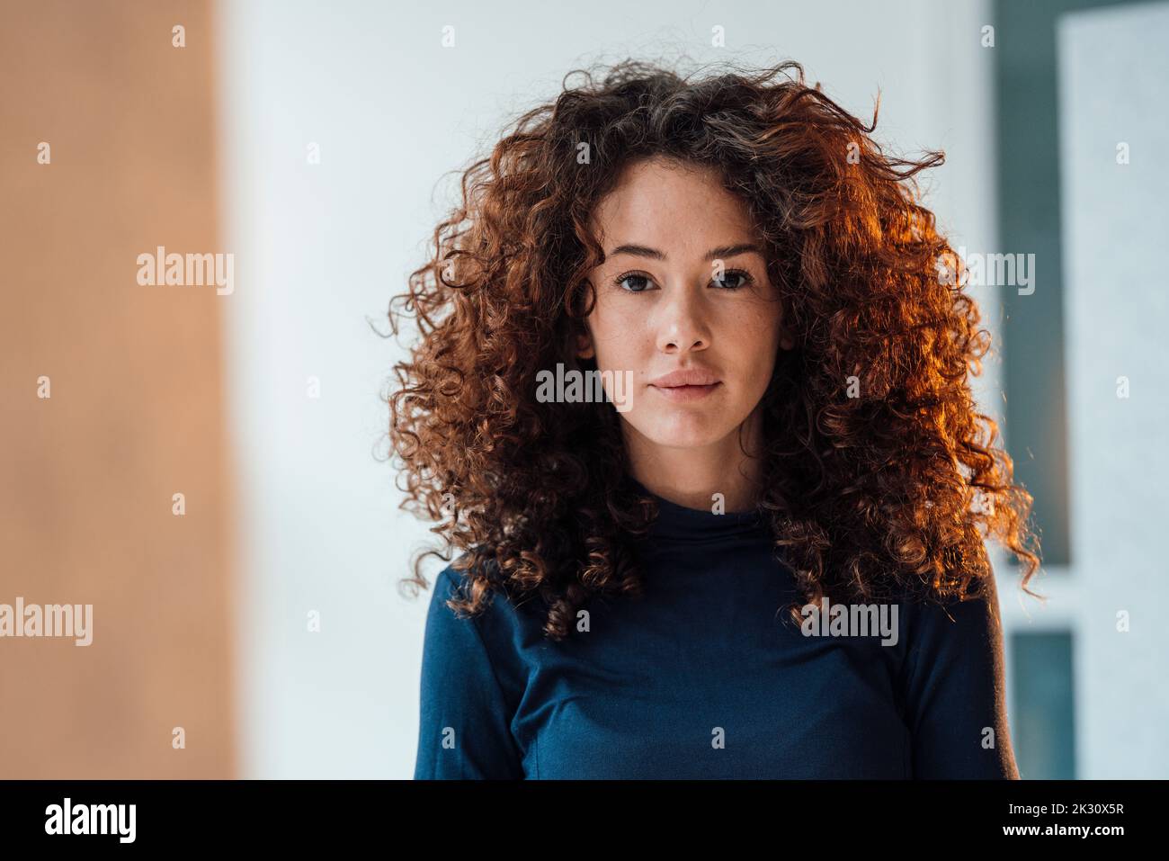 Beautiful young woman with curly hair Stock Photo - Alamy