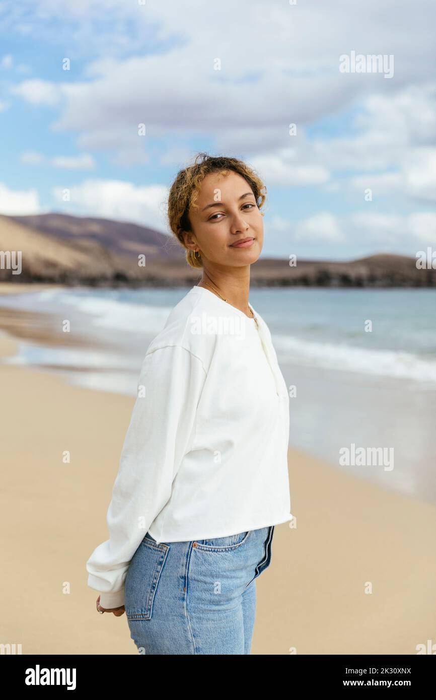 Young person standing at beach hi-res stock photography and images - Alamy