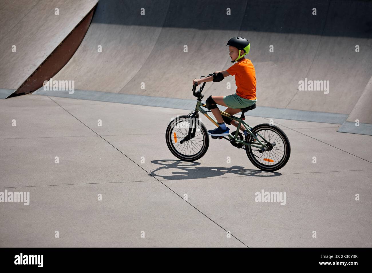 Boy riding BMX bike at skateboard park Stock Photo Alamy