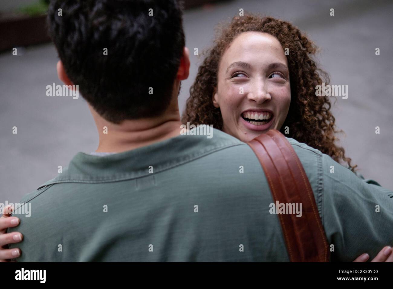 Happy young woman hugging boyfriend at footpath Stock Photo - Alamy