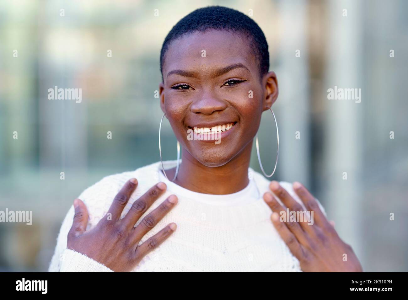 Happy woman wearing hoop earring Stock Photo