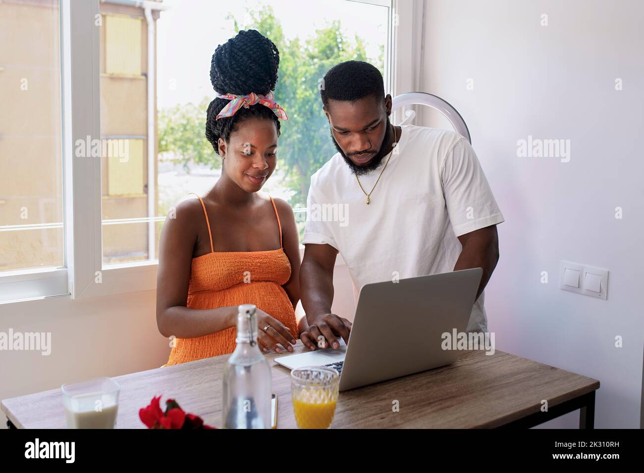 Multiracial couple using laptop on table at home Stock Photo